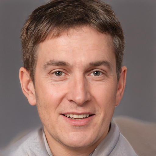 Joyful white adult male with short  brown hair and grey eyes