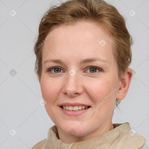 Joyful white adult female with medium  brown hair and blue eyes