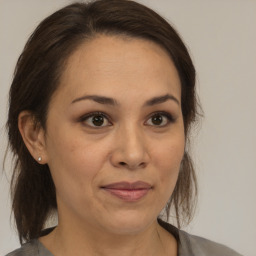 Joyful white adult female with medium  brown hair and brown eyes