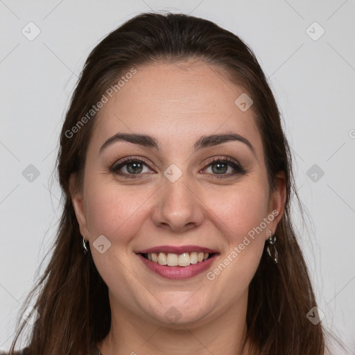 Joyful white young-adult female with long  brown hair and brown eyes