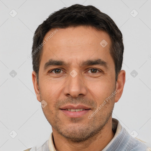 Joyful white adult male with short  black hair and brown eyes