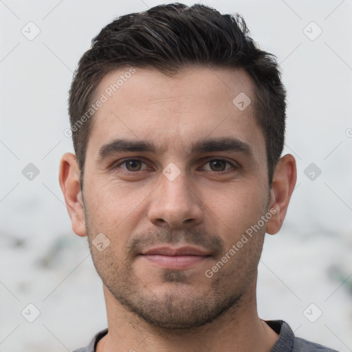 Joyful white young-adult male with short  brown hair and brown eyes