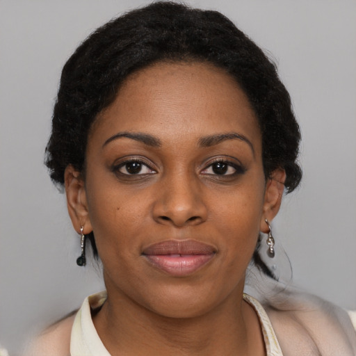 Joyful black young-adult female with medium  black hair and brown eyes