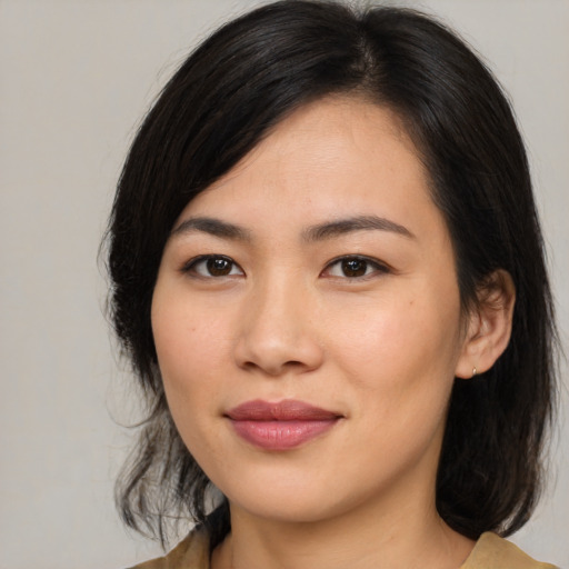 Joyful asian young-adult female with medium  brown hair and brown eyes