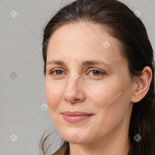 Joyful white adult female with long  brown hair and brown eyes