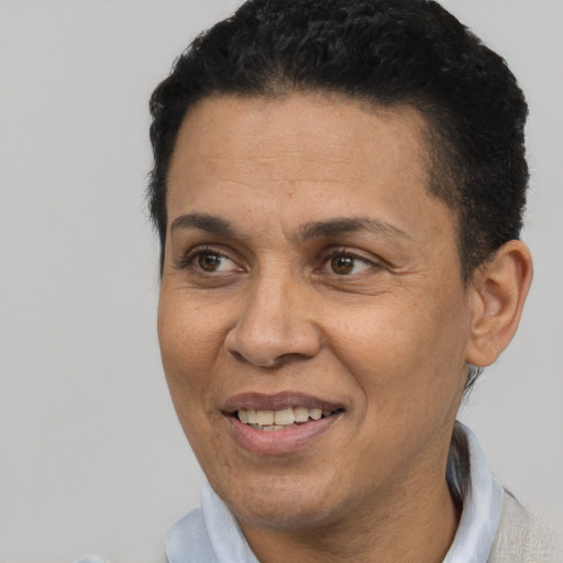 Joyful latino adult female with short  black hair and brown eyes