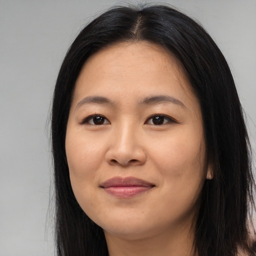 Joyful asian young-adult female with long  black hair and brown eyes