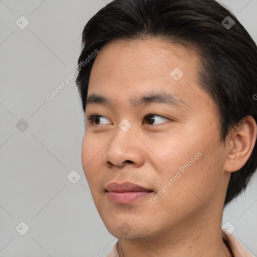 Joyful asian young-adult male with short  brown hair and brown eyes