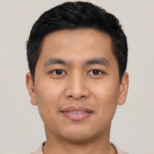 Joyful asian young-adult male with short  black hair and brown eyes