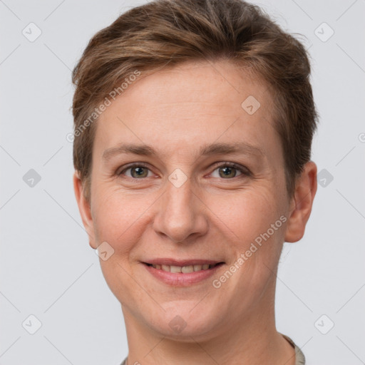 Joyful white adult female with short  brown hair and grey eyes