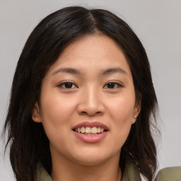 Joyful asian young-adult female with medium  brown hair and brown eyes