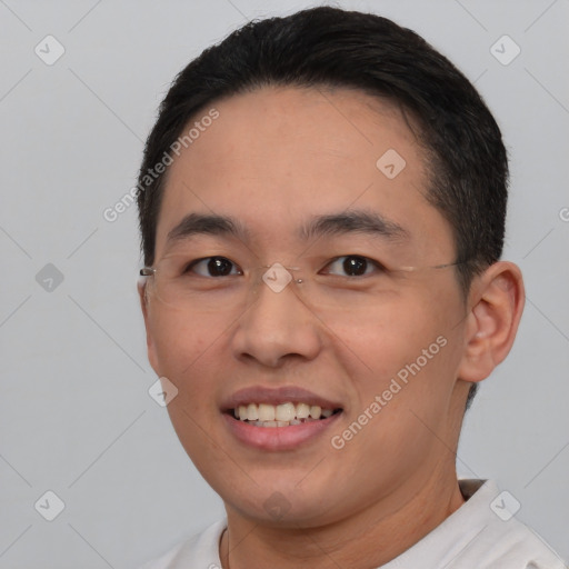 Joyful asian young-adult male with short  black hair and brown eyes