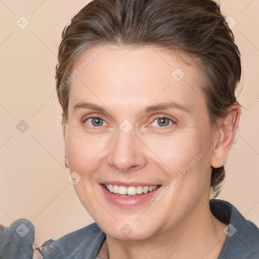 Joyful white adult female with medium  brown hair and grey eyes