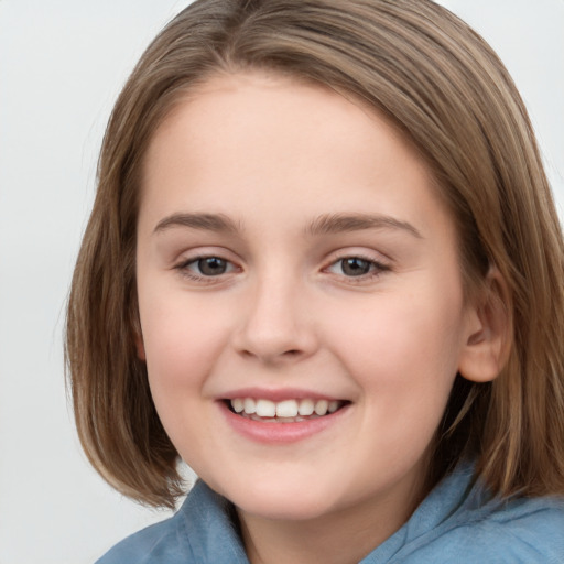 Joyful white child female with medium  brown hair and grey eyes