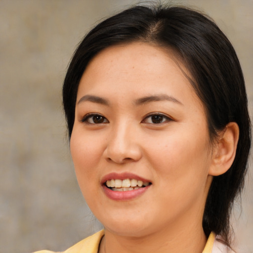 Joyful asian young-adult female with medium  brown hair and brown eyes