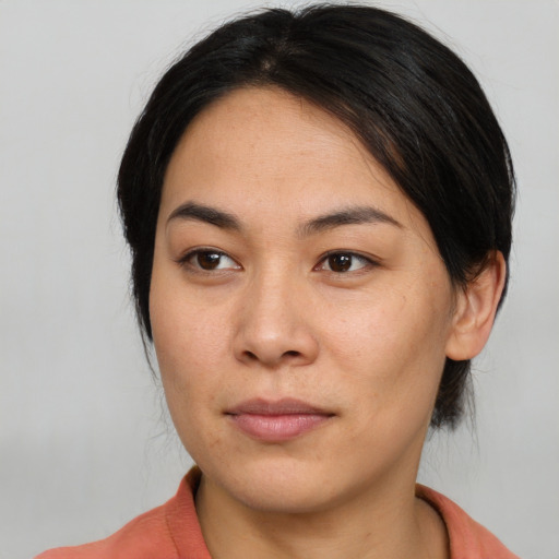 Joyful asian young-adult female with medium  brown hair and brown eyes