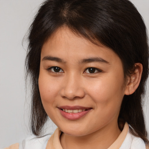 Joyful asian young-adult female with medium  brown hair and brown eyes