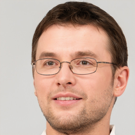 Joyful white young-adult male with short  brown hair and brown eyes