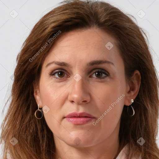 Joyful white adult female with long  brown hair and brown eyes