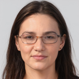 Joyful white adult female with long  brown hair and brown eyes