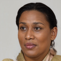 Joyful black adult female with medium  brown hair and brown eyes