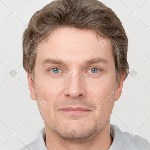 Joyful white adult male with short  brown hair and grey eyes