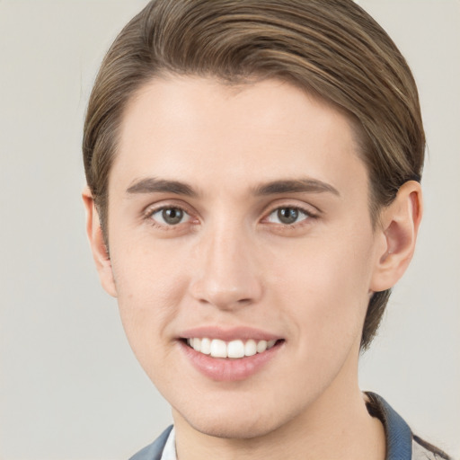 Joyful white young-adult male with short  brown hair and grey eyes