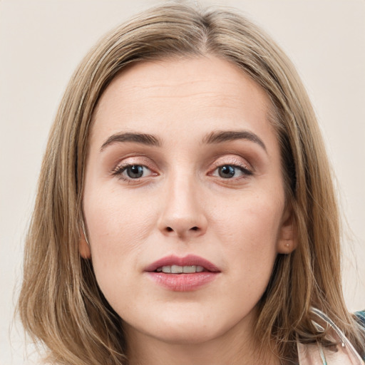 Joyful white young-adult female with long  brown hair and green eyes