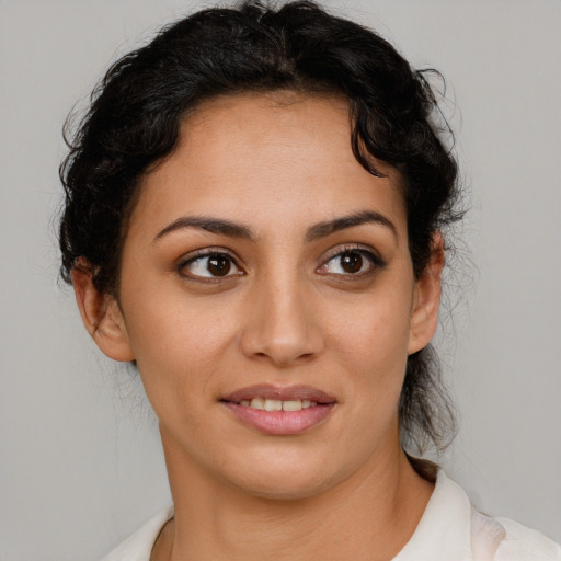 Joyful latino young-adult female with medium  brown hair and brown eyes