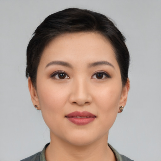 Joyful asian young-adult female with short  black hair and brown eyes