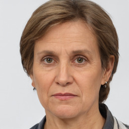 Joyful white middle-aged female with medium  brown hair and grey eyes