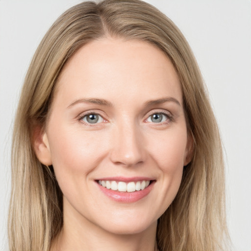 Joyful white young-adult female with long  brown hair and blue eyes