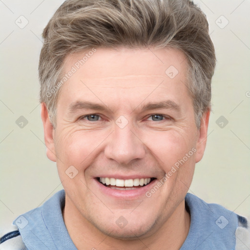 Joyful white adult male with short  brown hair and grey eyes