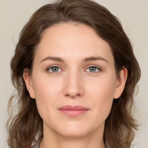 Joyful white young-adult female with medium  brown hair and green eyes