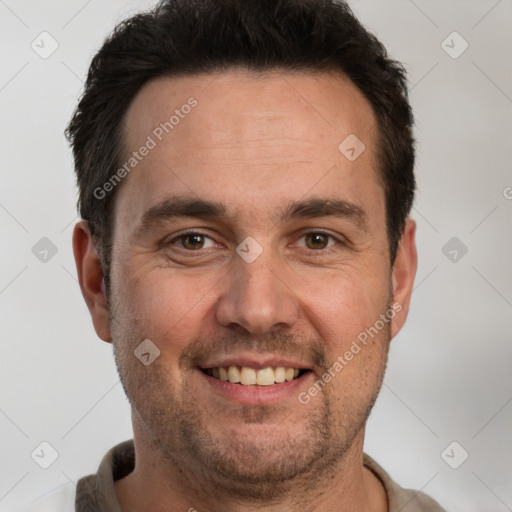 Joyful white adult male with short  brown hair and brown eyes