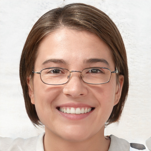 Joyful white young-adult female with medium  brown hair and blue eyes