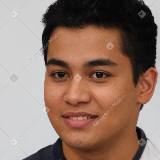 Joyful latino young-adult male with short  black hair and brown eyes