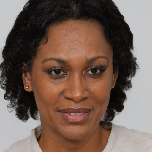 Joyful black adult female with short  brown hair and brown eyes