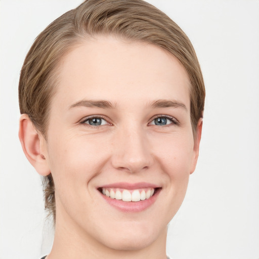 Joyful white young-adult female with short  brown hair and grey eyes