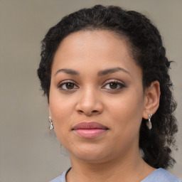 Joyful black young-adult female with medium  brown hair and brown eyes