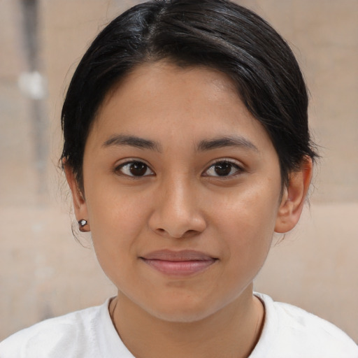 Joyful latino young-adult female with medium  brown hair and brown eyes