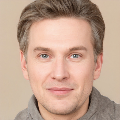 Joyful white adult male with short  brown hair and grey eyes