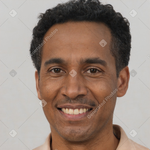 Joyful latino adult male with short  black hair and brown eyes