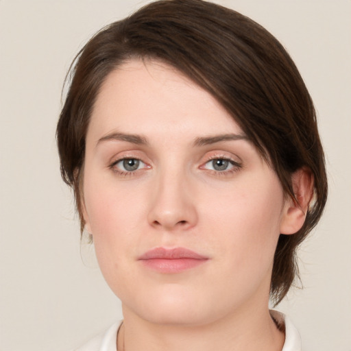 Neutral white young-adult female with medium  brown hair and green eyes