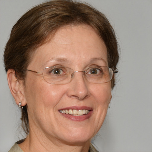 Joyful white middle-aged female with medium  brown hair and blue eyes