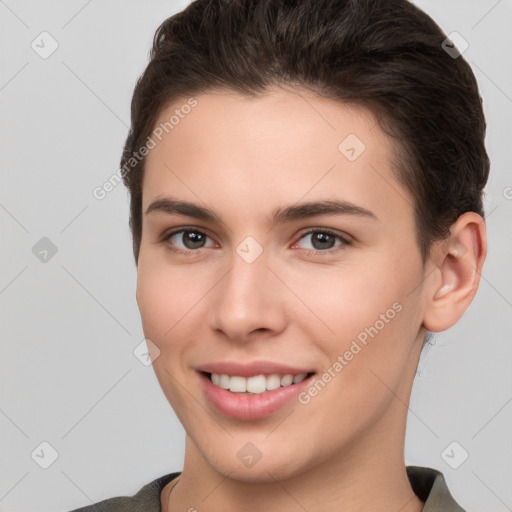 Joyful white young-adult female with short  brown hair and brown eyes