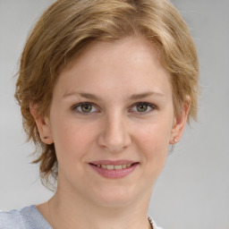 Joyful white young-adult female with medium  brown hair and blue eyes