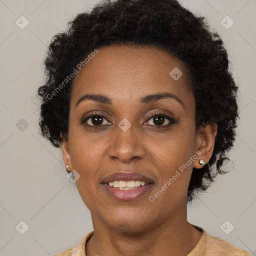 Joyful black adult female with short  brown hair and brown eyes