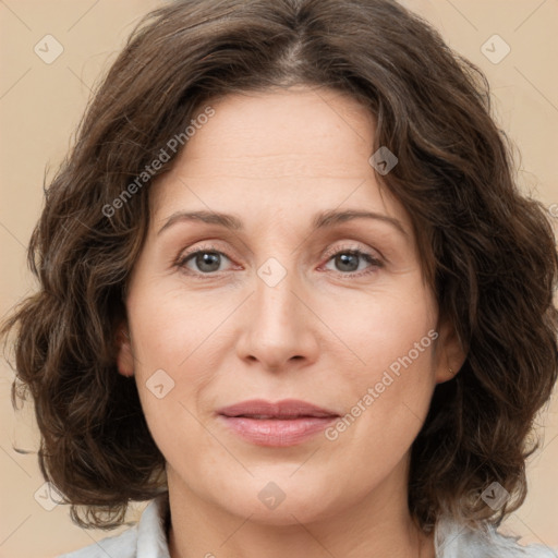 Joyful white adult female with medium  brown hair and green eyes