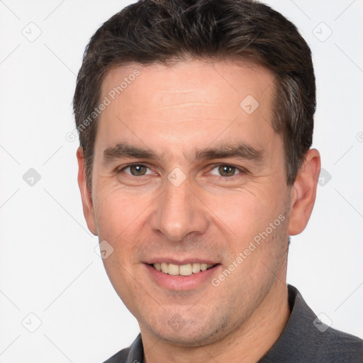 Joyful white adult male with short  brown hair and brown eyes